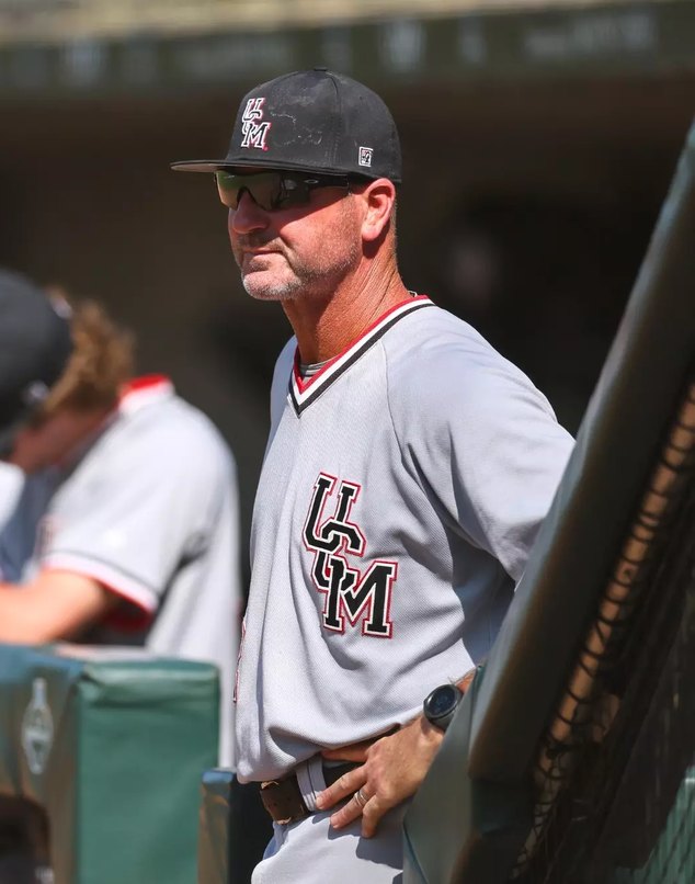 Head coach Kyle Crookes watching from the dugout
