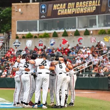 Mules huddle under the championship scoreboard