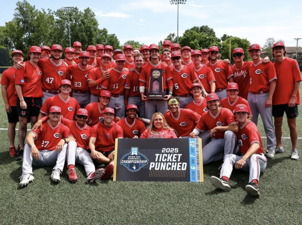 2025 Mules team photo with the Ticket Punched sign and trophy